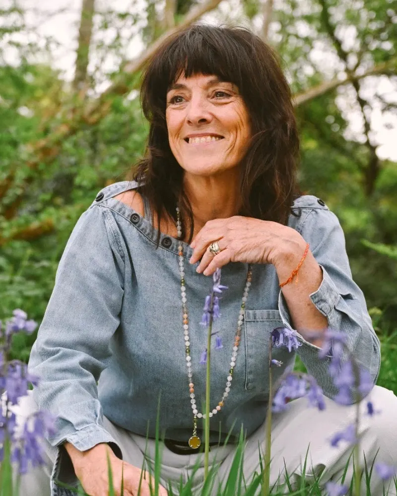 Catherine smiling among bluebells in a Kerry woodland