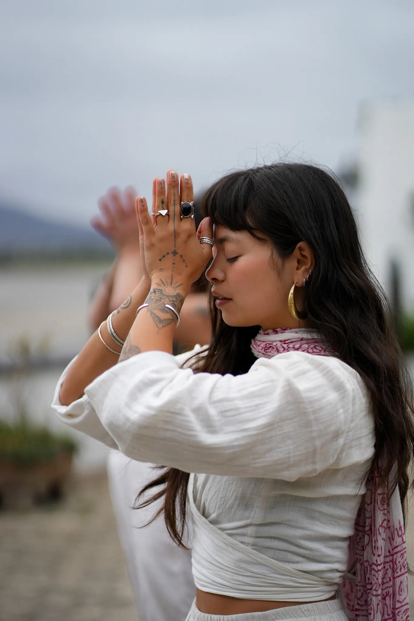Dani, eyes closed, hands together in prayer