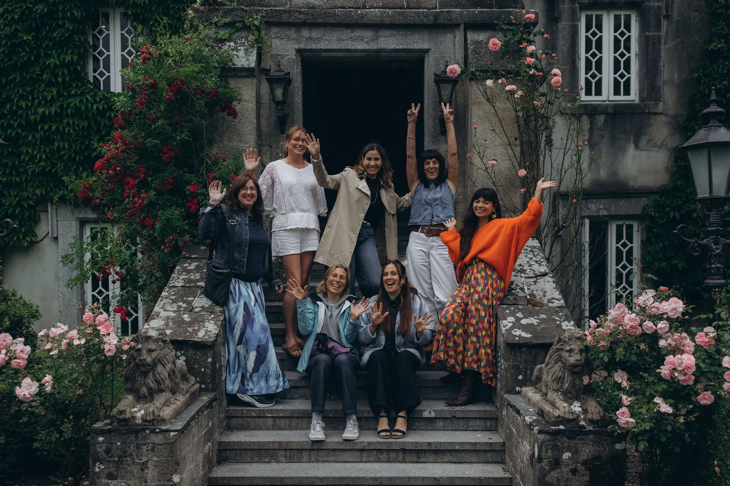Retreat guests smiling on the stone steps of Barrow House