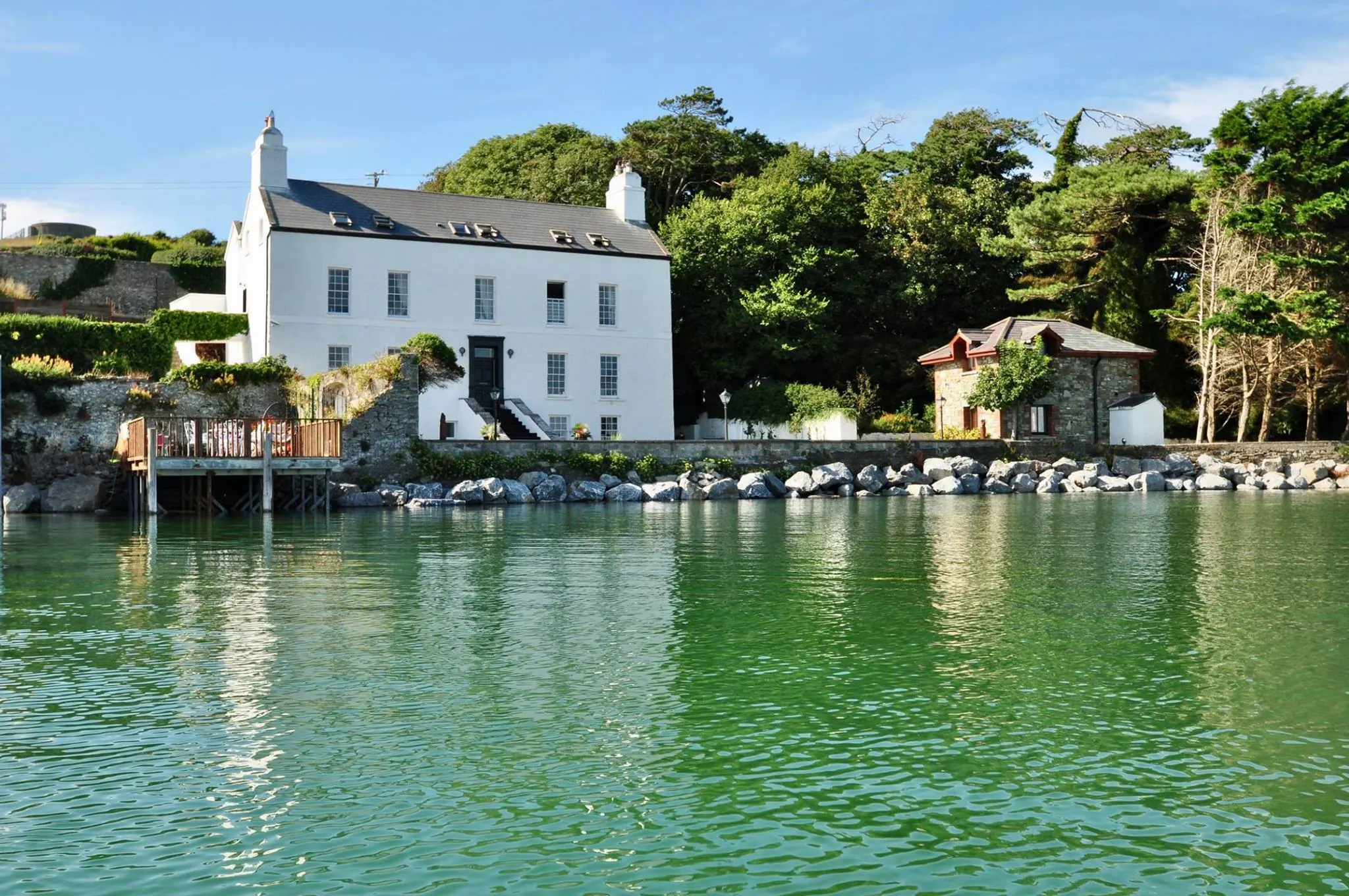 Barrow House, a white Georgian house on the water's edge