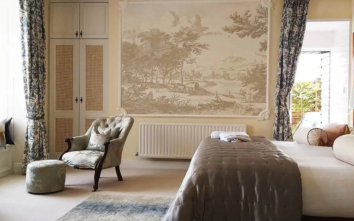 A guest bedroom with a painted mural