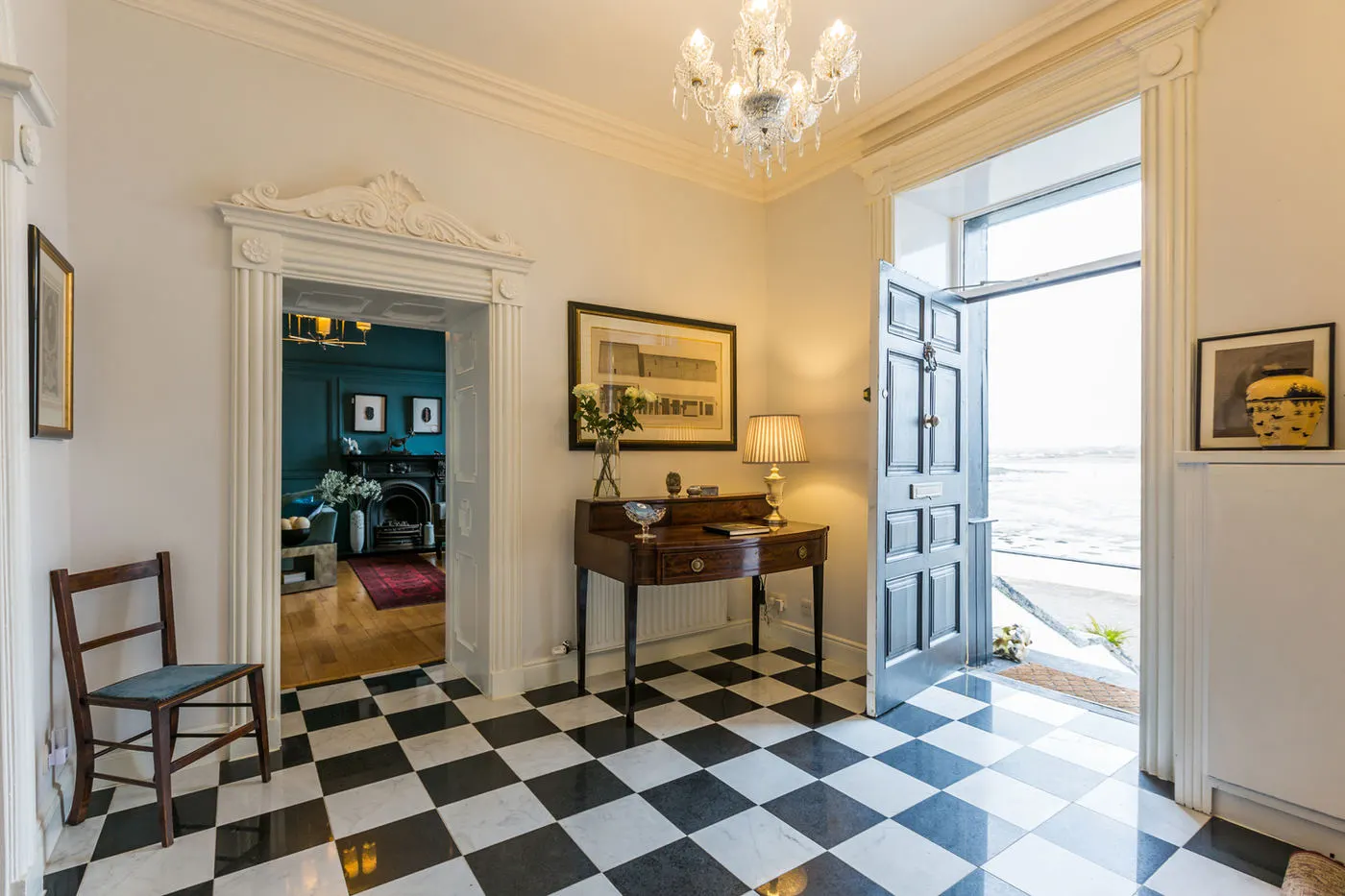 The entrance hall with a chequered marble floor