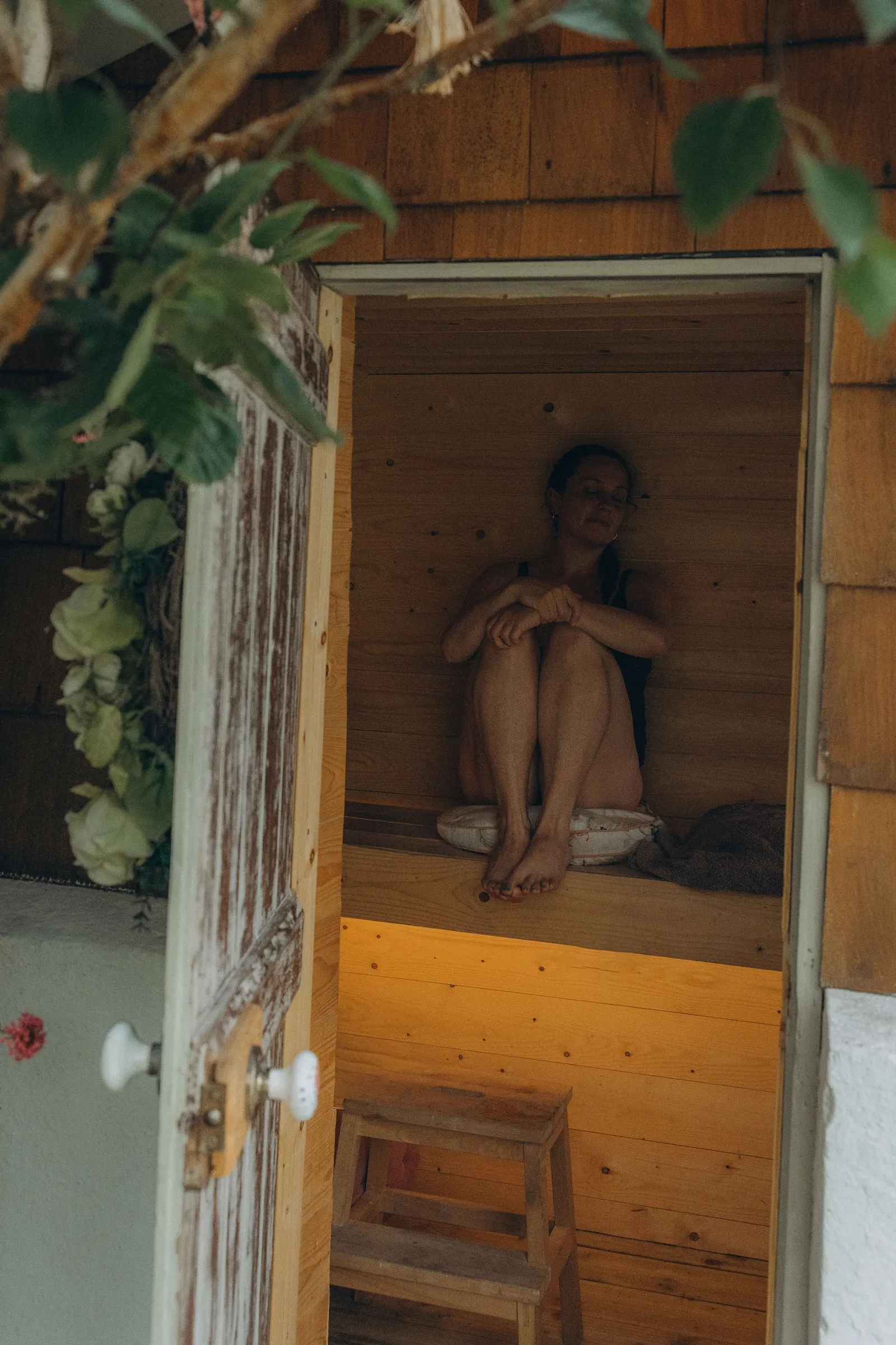 A guest resting in the wooden outdoor sauna