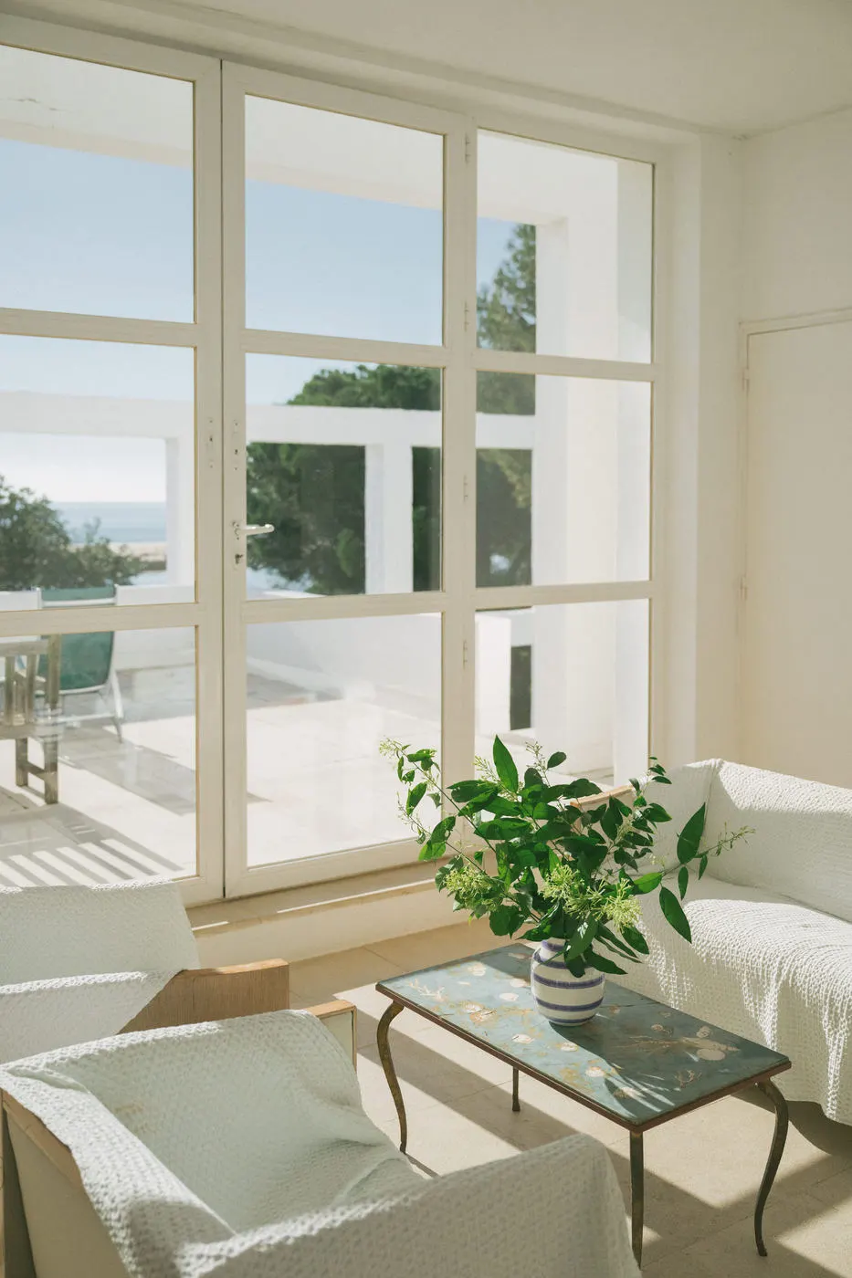 A sunlit sitting room with garden doors