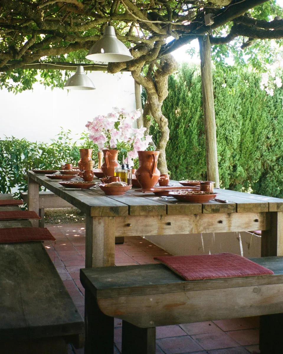 Outdoor dining table under a pergola