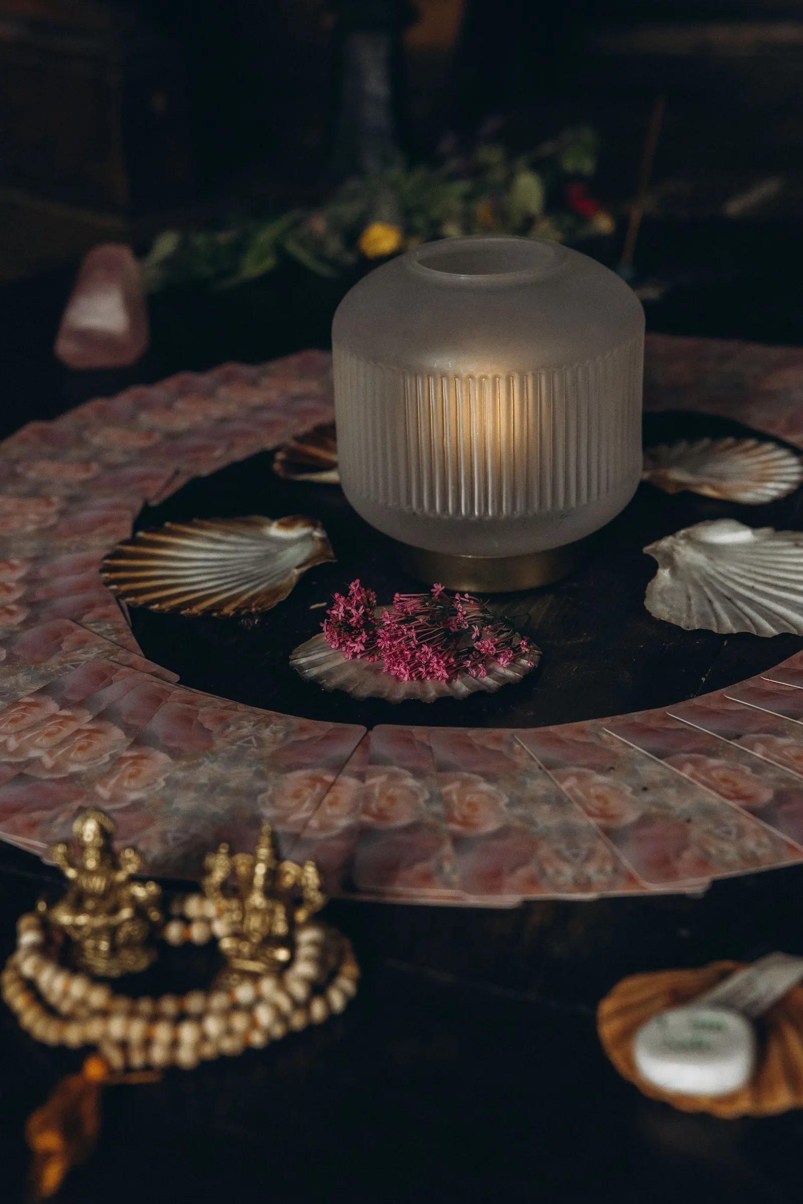 A candle, shells and flowers laid out for a ritual