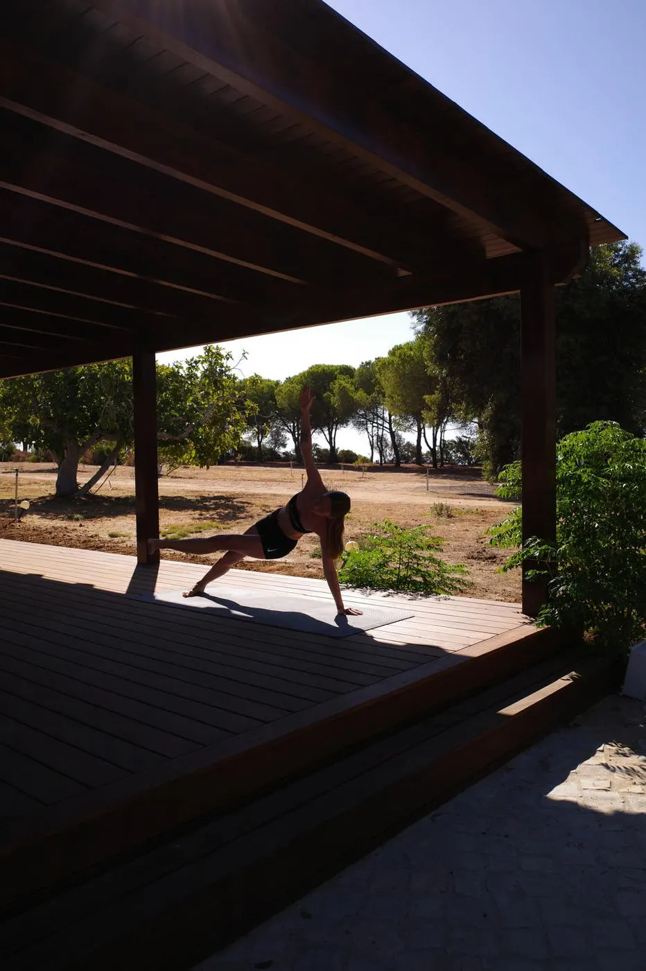 A guest in a side plank on the open-air yoga deck